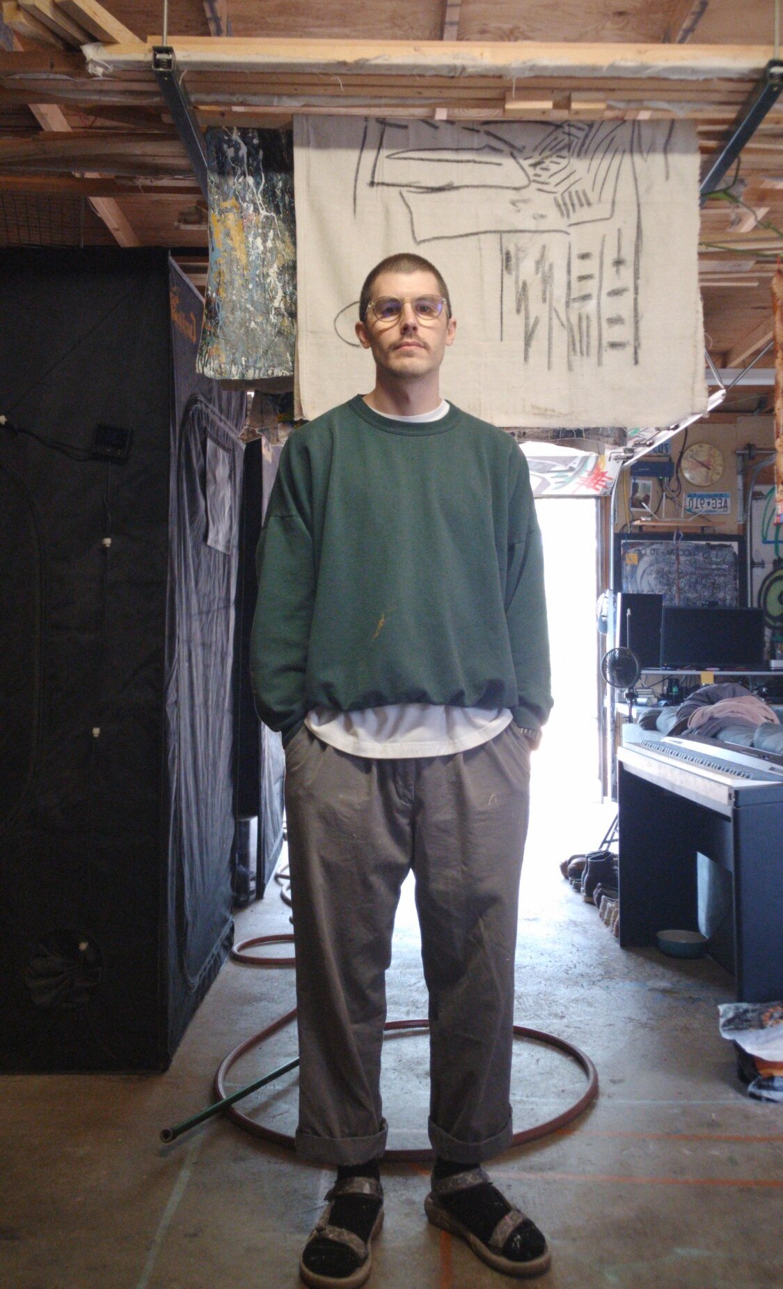 Jake DeBus standing in his studio