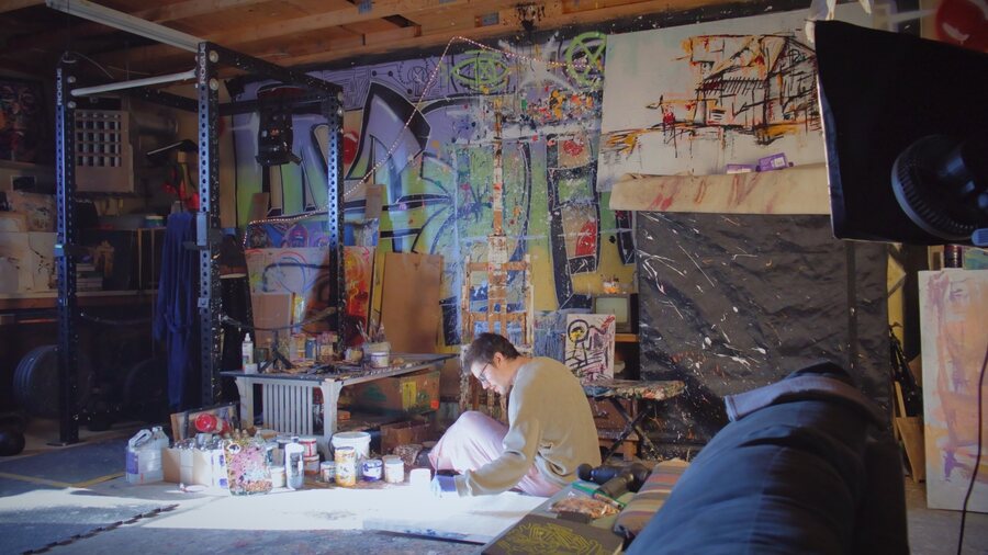 Jake DeBus painting on the studio floor